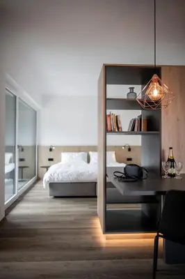 a bedroom with a bed and a desk and a bed at Sambucus Apartments -Premium Apartments for You and Your Dog in Lana