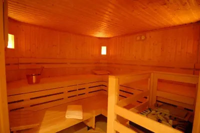 a wooden sauna with a bench in the middle at Hotel Römerrast in Caldaro