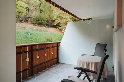 a balcony with a desk and a chair and a window at Hotel Römerrast in Caldaro