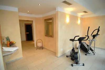 a gym with two exercise bikes in a room at Hotel Römerrast in Caldaro