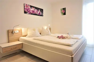 a bedroom with a bed with flowers on it at Zum Schwarzen Kus in Caldaro