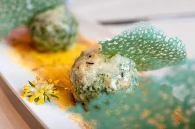 a plate of food with a prickly fruit and a flower at Hotel Cant del Gal in Fiera di Primiero