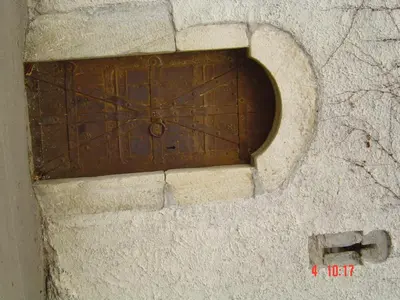 a brown wooden door in a stone wall at Obergereuth Hof 1288 in San Martino