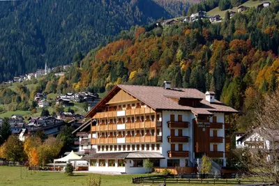 a large building in the middle of a mountain at Sport Hotel Cristal in Falcade