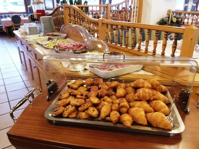 a bunch of doughnuts on a tray on a table at Sport Hotel Cristal in Falcade
