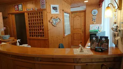 a kitchen with a wooden counter top in a room at Sport Hotel Cristal in Falcade