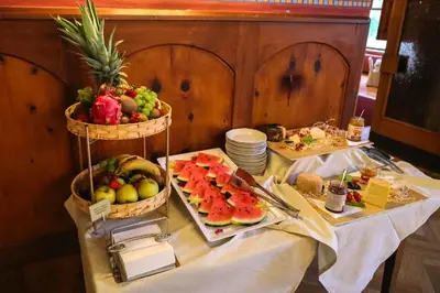 a table with two baskets of fruit on it at Hotel Lago di Braies in Braies
