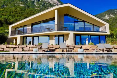 a house with a pool in front of it at Papstlhof in Caldaro