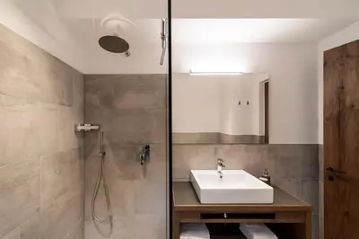 a bathroom with a sink and a shower at Papstlhof in Caldaro