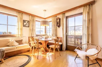 a living room with a table and chairs and a couch at Ferienhaus Winkler in Anterivo