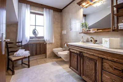 a bathroom with a sink and a toilet and a window at Ferienhaus Winkler in Anterivo
