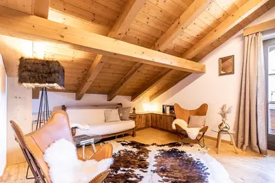a living room with a white couch and chairs at Ferienhaus Winkler in Anterivo