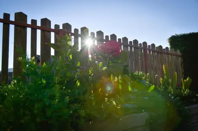 a wooden fence with the sun shining behind it at Ferienhaus Winkler in Anterivo