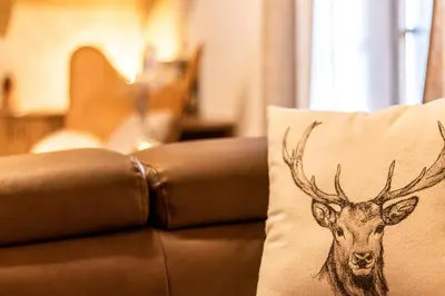 a pillow with a deer head on it sitting on a couch at Ferienhaus Winkler in Anterivo