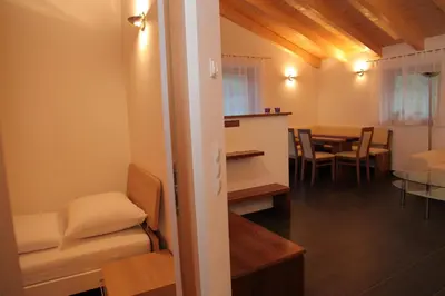 a room with a table and a dining room at El Paradiso in Naturno