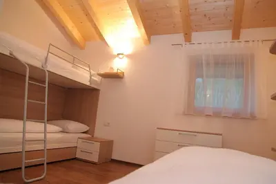 a bedroom with a bunk bed and a window at El Paradiso in Naturno