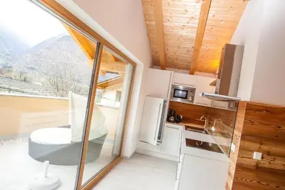 a room with a kitchen with a view of a mountain at El Paradiso in Naturno