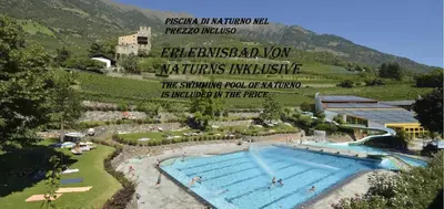 a swimming pool with a sign that reads emergency bad loan waters inclusive at El Paradiso in Naturno