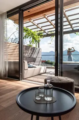 a coffee table in a room with a view of the ocean at Boutique Hotel Eschenlohe Adults only in Schenna