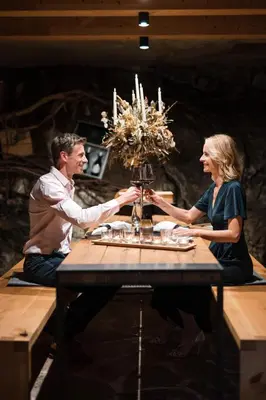 a man and a woman sitting at a table at Boutique Hotel Eschenlohe Adults only in Schenna