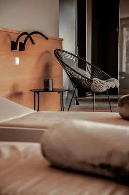 a room with a hammock chair and a table at Boutique Hotel Eschenlohe Adults only in Schenna