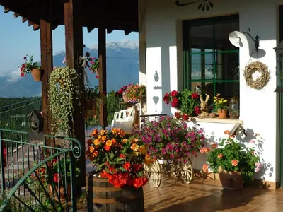 a house with flowers on the front of it at La Capannina in Coredo