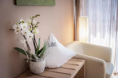 a vase of flowers on a table in a living room at Living Puez in Funes