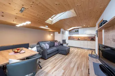 a living room with a couch and a table at Living Puez in Funes
