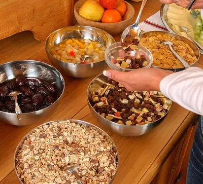 a table topped with bowls of different types of food at Haus Tirol in Molini di Tures