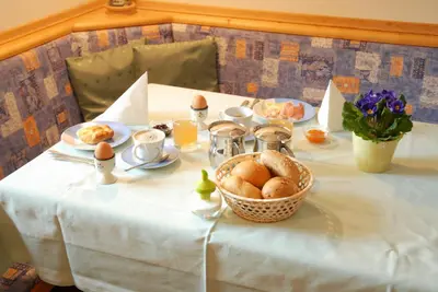 a table with eggs and a basket of bread at Biohof Hamann in Sarntal