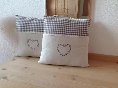 a pillow sitting on top of a wooden floor at Biohof Hamann in Sarntal