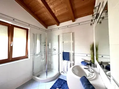 a bedroom with a bed and a window at Schloss-Hof in Appiano sulla Strada del Vino