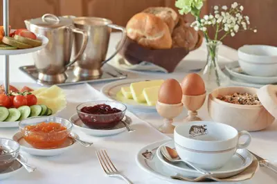 a table with eggs and other food on it at Hotel Bewaller in Obereggen