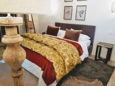 a bedroom with a bed and a table with a lamp at Your secret place to stay - Therme Meran in Merano