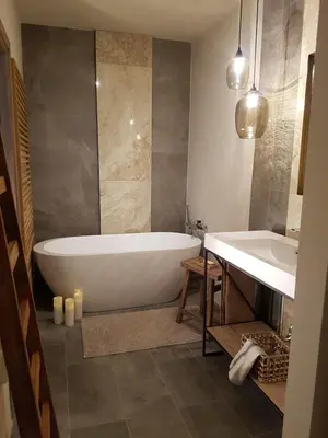 a bathroom with a bath tub and a sink at Your secret place to stay - Therme Meran in Merano