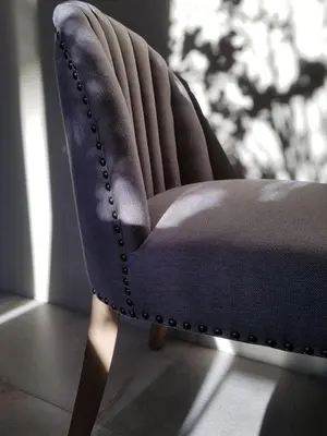 a blue chair sitting in front of a window at Your secret place to stay - Therme Meran in Merano