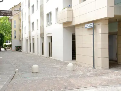 an empty street in front of a building at Stay COOPER l Cà de Bezzi in Bolzano