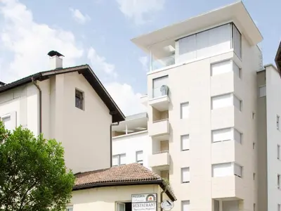 an apartment building with a white facade at Stay COOPER l Cà de Bezzi in Bolzano