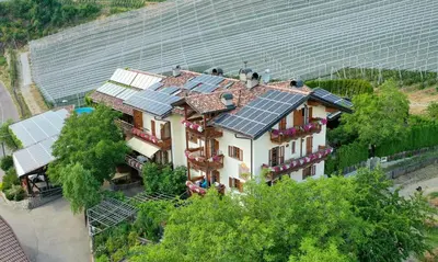 a house with solar panels on top of it at Obergostnerhof in Chiusa