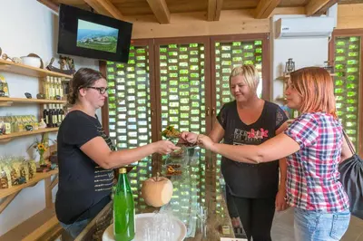 a group of three women standing at a bar pouring drinks at Obergostnerhof in Chiusa