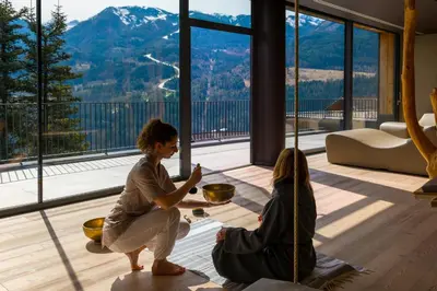 a table with a cup of coffee and a glass of orange juice at La Roccia Wellness Hotel in Cavalese