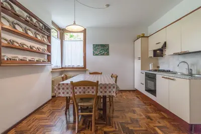 a kitchen with a table and chairs in a room at Villa Licia in Falcade