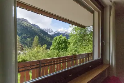a window with a view of the mountains at Villa Licia in Falcade