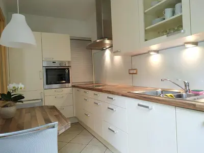 a kitchen with white cabinets and a sink at Appartment Trojer in Merano