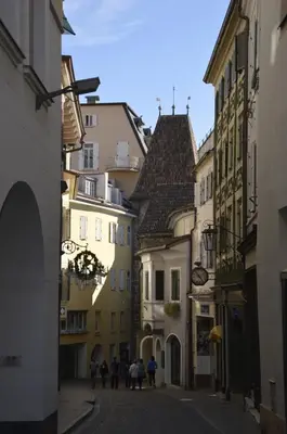 a group of people walking down a street with buildings at Appartment Trojer in Merano