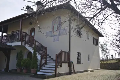 a white building with stairs on the side of it at Weingut Hochleiten in Caldaro