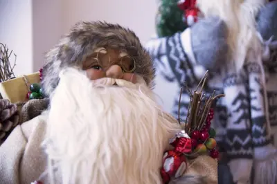 a santa claus figurine is sitting on a chair at Piccola Cesa Apartments in Canazei
