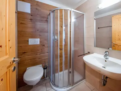 a bathroom with a shower and a toilet and a sink at Holiday Home Mantel by Interhome in Mazzin