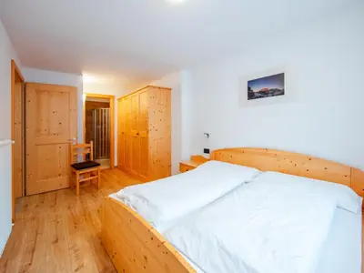 a bedroom with a large wooden bed in a room at Holiday Home Mantel by Interhome in Mazzin