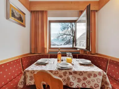 a dining room with a table and a window at Apartment Lazzer-1 by Interhome in Campitello